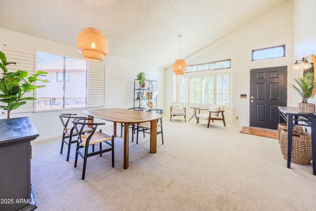 a dining room with furniture and a floor to ceiling window