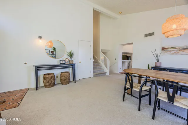 a bedroom with furniture and a mirror