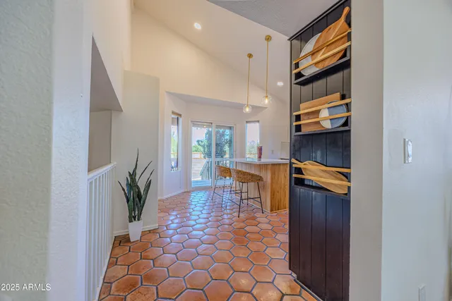 a living room with furniture and a painting on the wall
