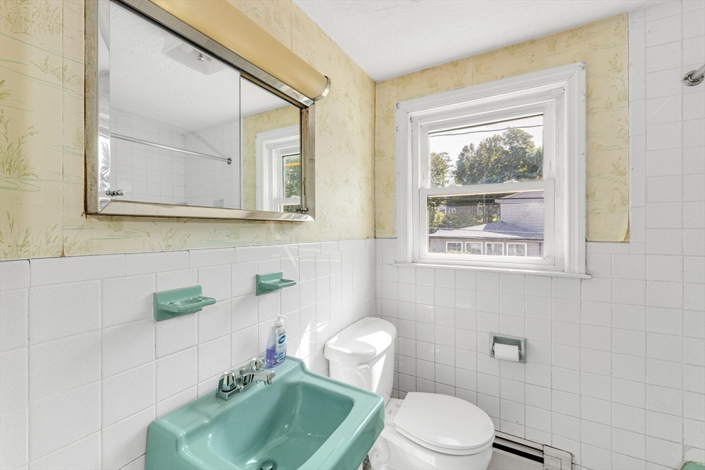 44 Milton Avenue Boston, MA 02136 - Photo 14 of 32 a white toilet sitting next to a bathroom sink