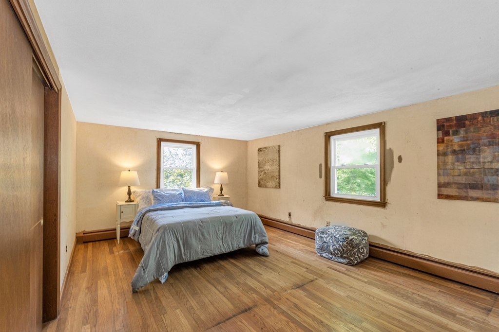 44 Milton Avenue Boston, MA 02136 - Photo 17 of 32 a bedroom with a bed and wooden floor
