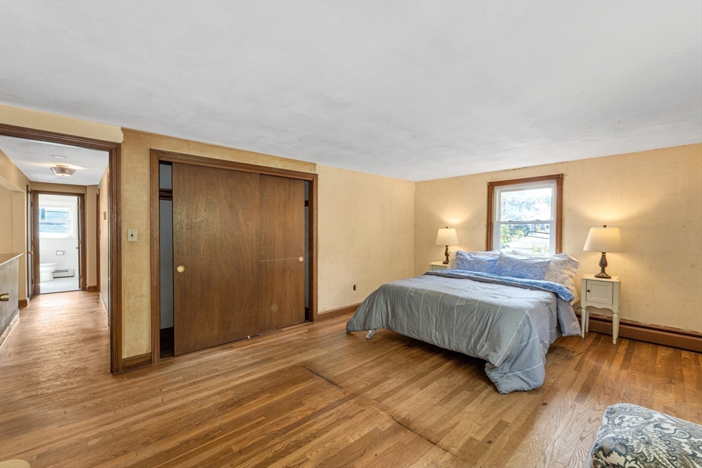 44 Milton Avenue Boston, MA 02136 - Photo 18 of 32 a bedroom with a bed and wooden floor