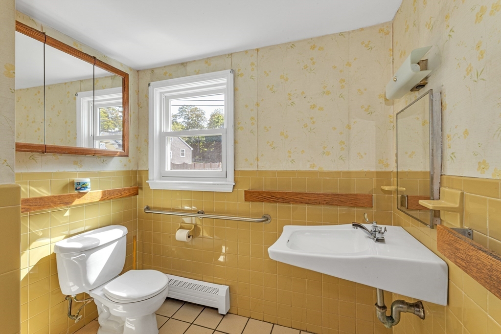 44 Milton Avenue Boston, MA 02136 - Photo 22 of 32 a bathroom with a sink and mirror with toilet