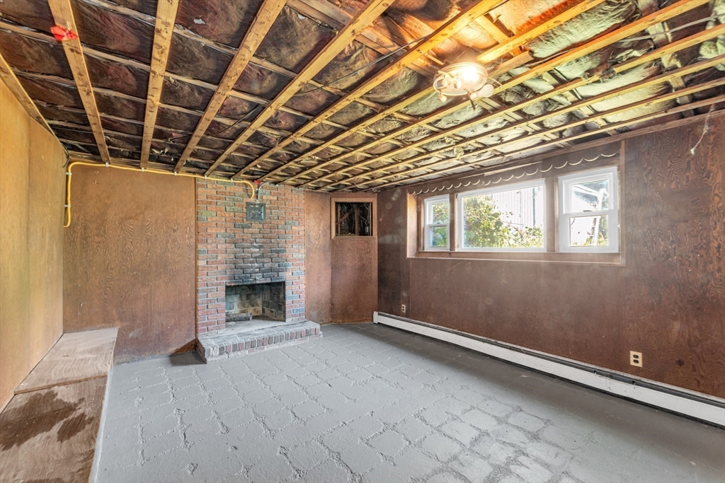 44 Milton Avenue Boston, MA 02136 - Photo 25 of 32 a view of empty room with wooden floor and fireplace