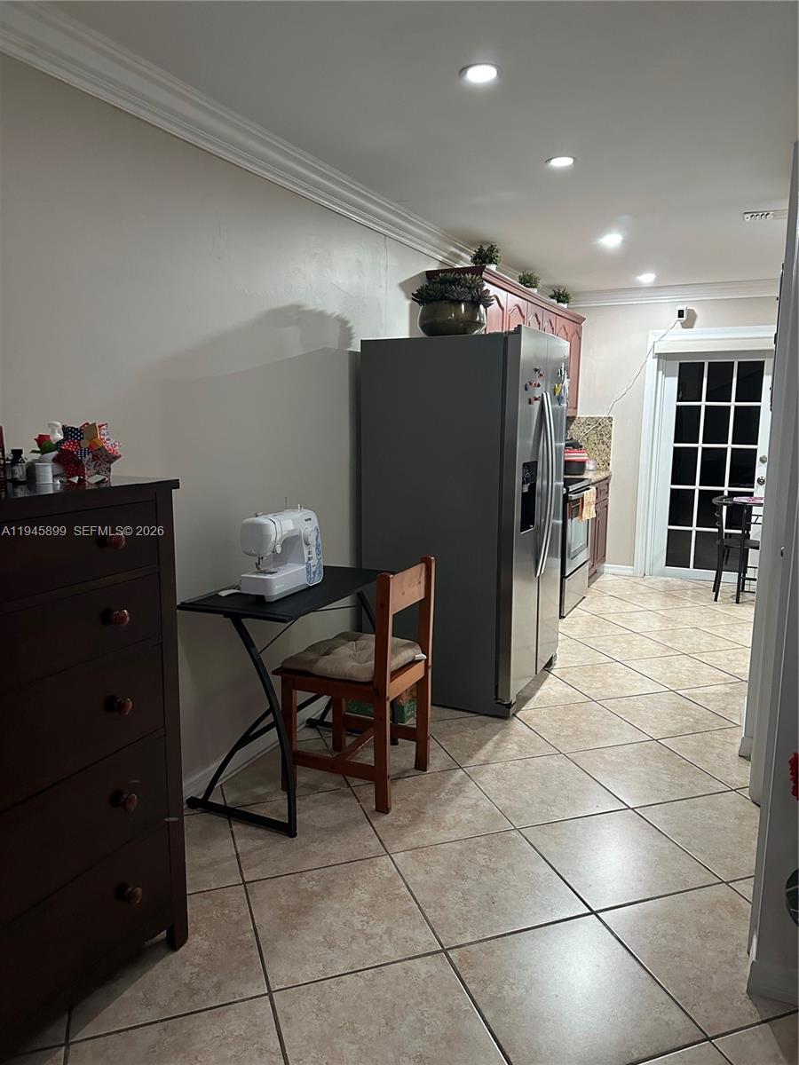 13220 Southwest 58th Terrace, Unit 166 Miami, FL 33183 - Photo 2 of 4 a view of a workspace with furniture and a potted plant