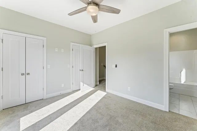 a view of a bedroom with closet and bathroom