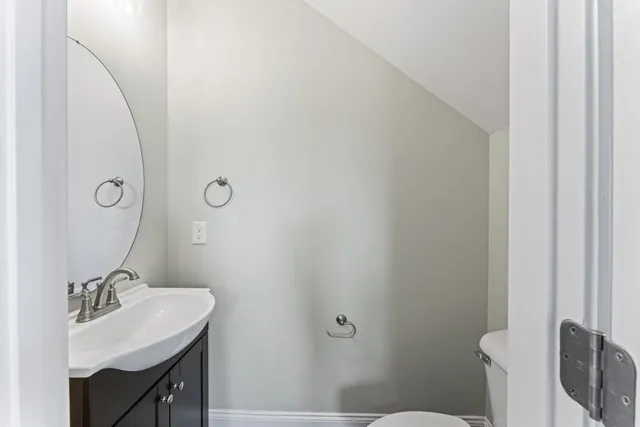 a bathroom with a sink toilet and mirror