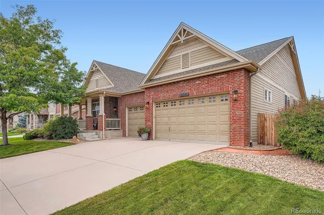 a front view of a house with a garden and yard