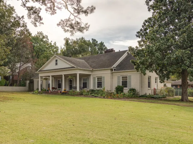 a front view of a house with a garden
