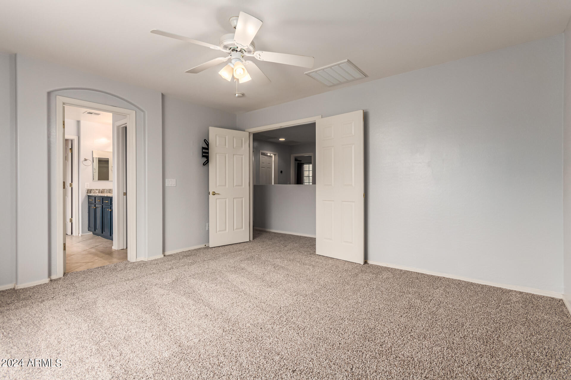 2626 West Florentine Road Phoenix, AZ 85086 - Photo 12 of 20 an empty room with closet and a ceiling fan