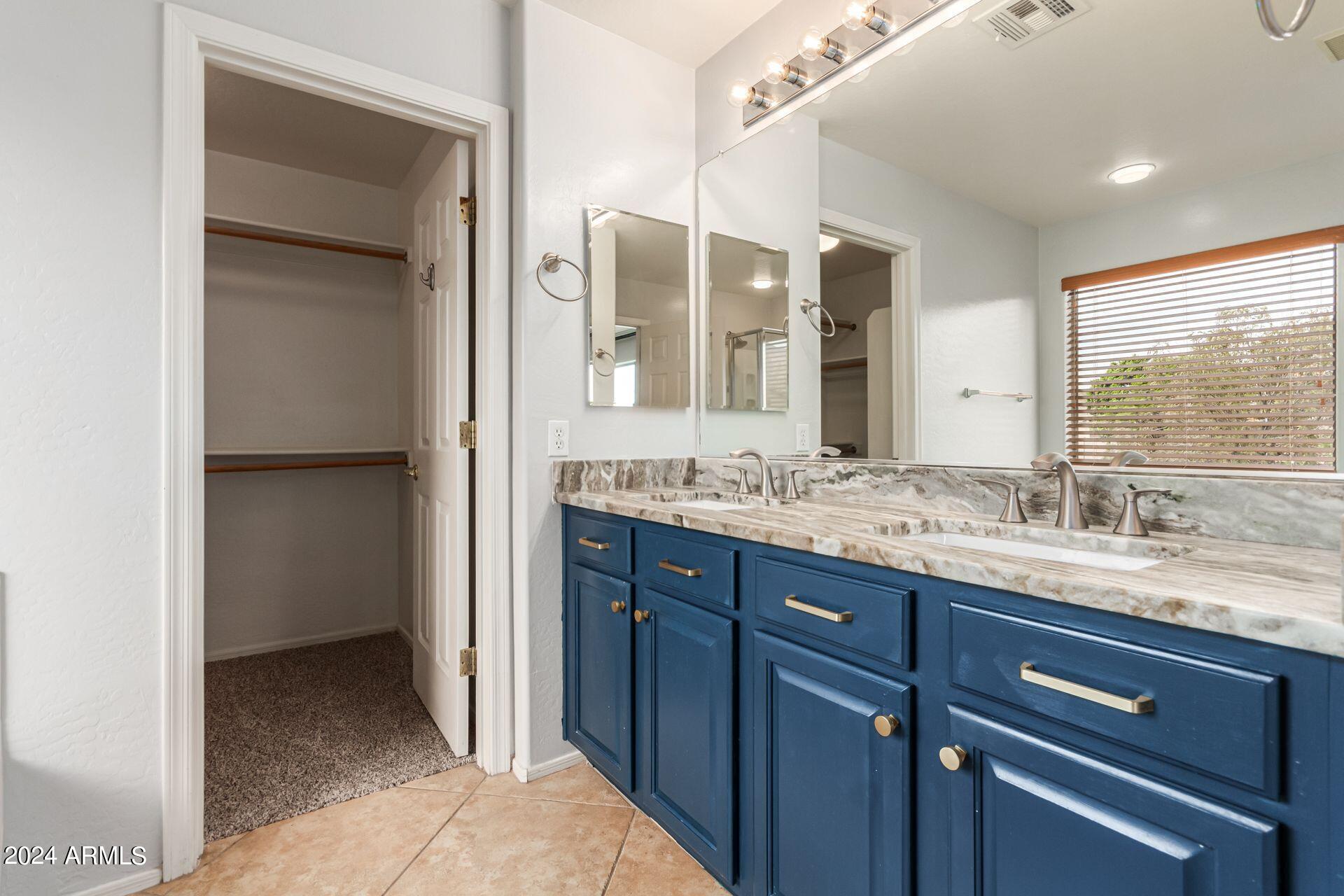2626 West Florentine Road Phoenix, AZ 85086 - Photo 13 of 20 a bathroom with a granite countertop sink and a mirror