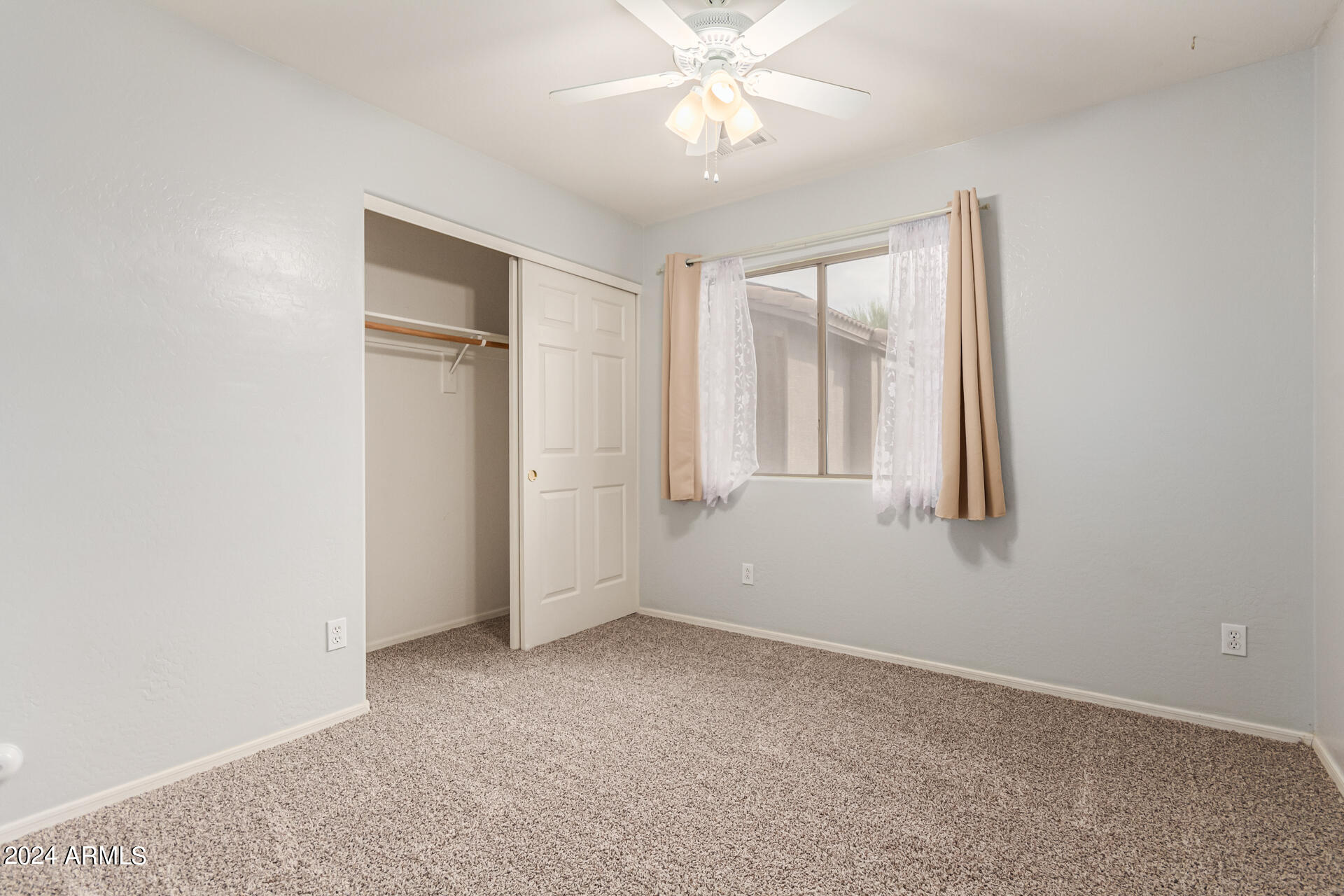 2626 West Florentine Road Phoenix, AZ 85086 - Photo 17 of 20 an empty room with windows and fan