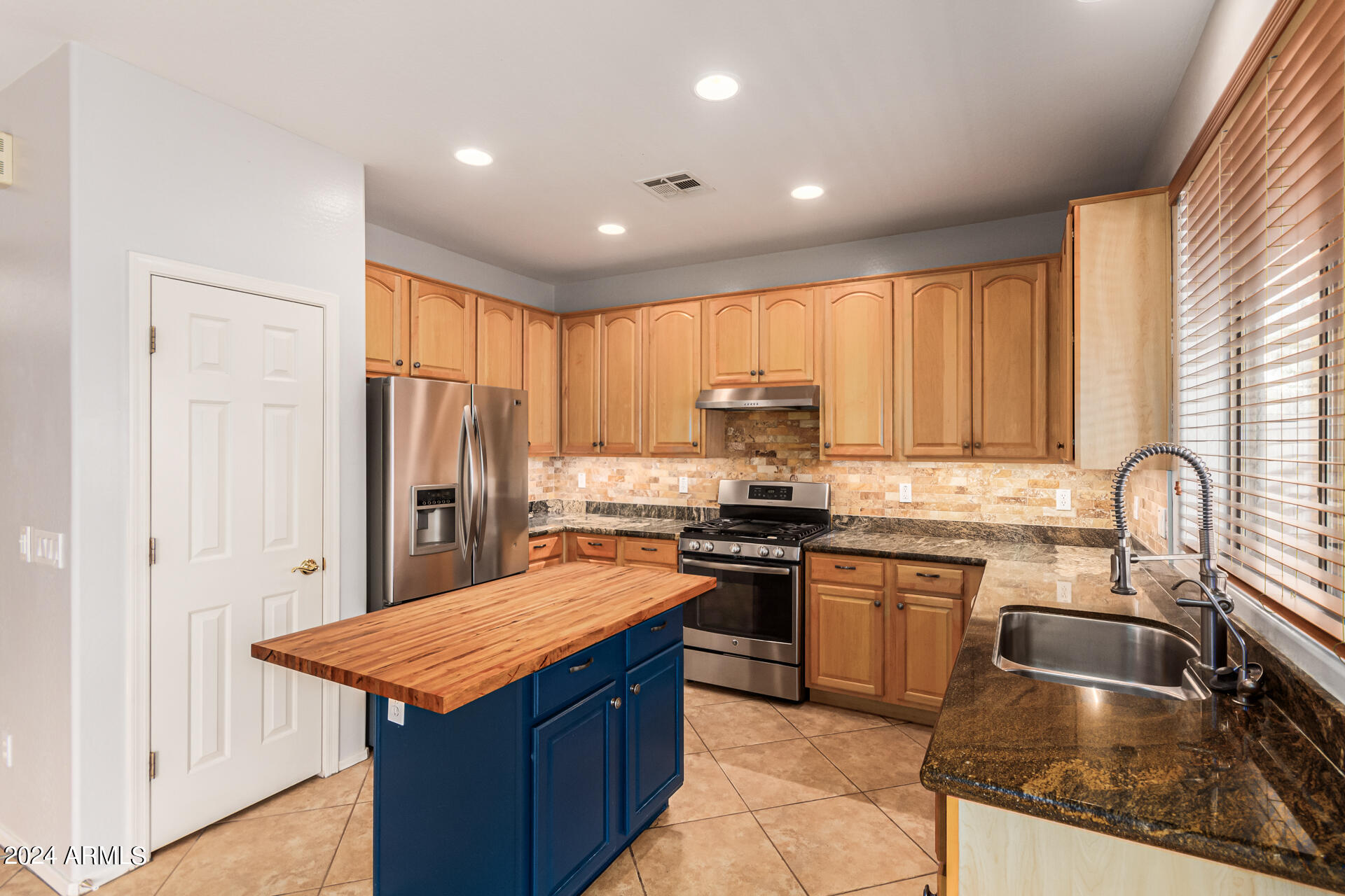 2626 West Florentine Road Phoenix, AZ 85086 - Photo 3 of 20 a kitchen with stainless steel appliances granite countertop a sink stove and refrigerator