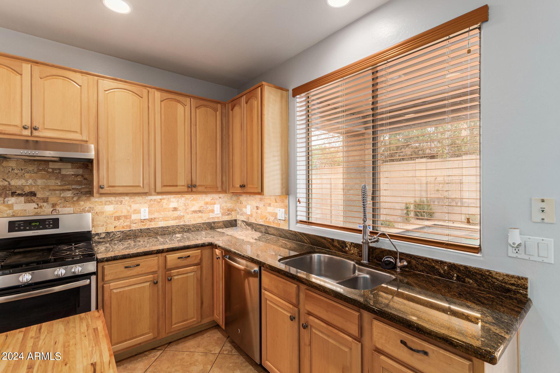 2626 West Florentine Road Phoenix, AZ 85086 - Photo 5 of 20 a kitchen with a sink stove and cabinets