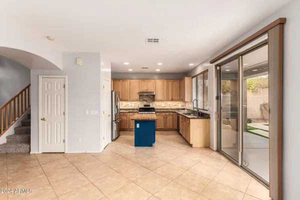 a kitchen with stainless steel appliances granite countertop a refrigerator and a sink