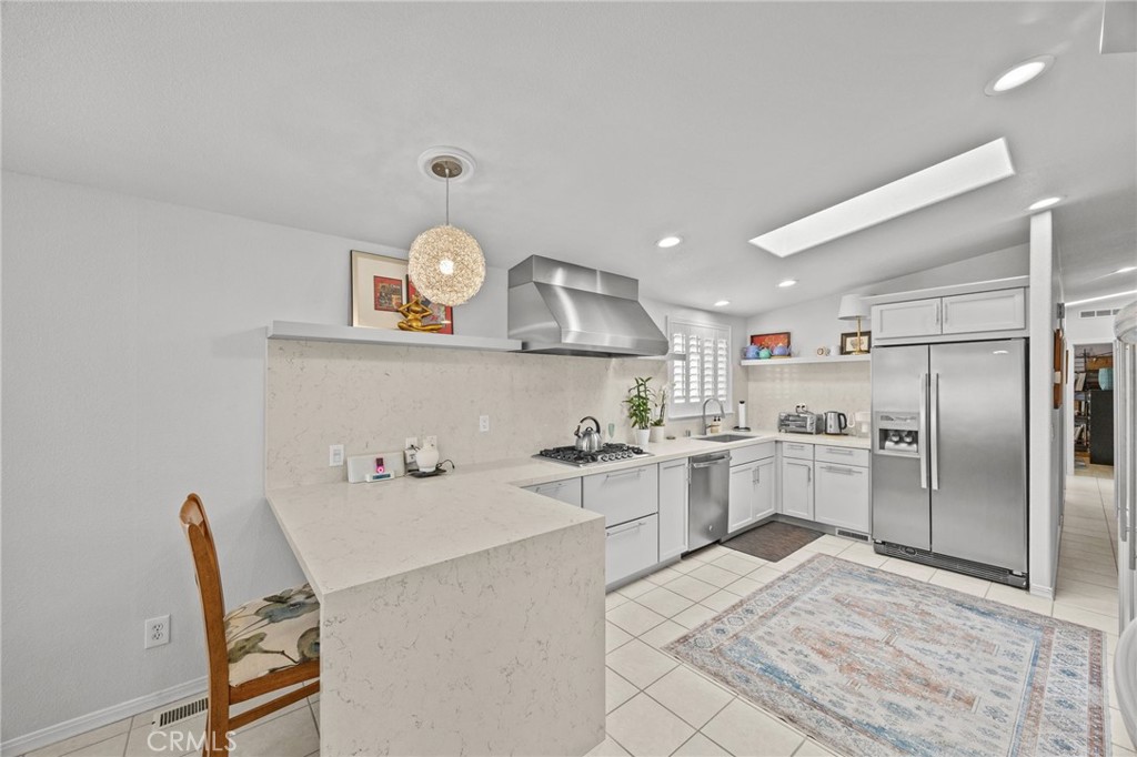 23301 Ridge Rte Drive, Unit 246 Laguna Hills, CA 92653 - Photo 11 of 35 a kitchen with a refrigerator and a sink