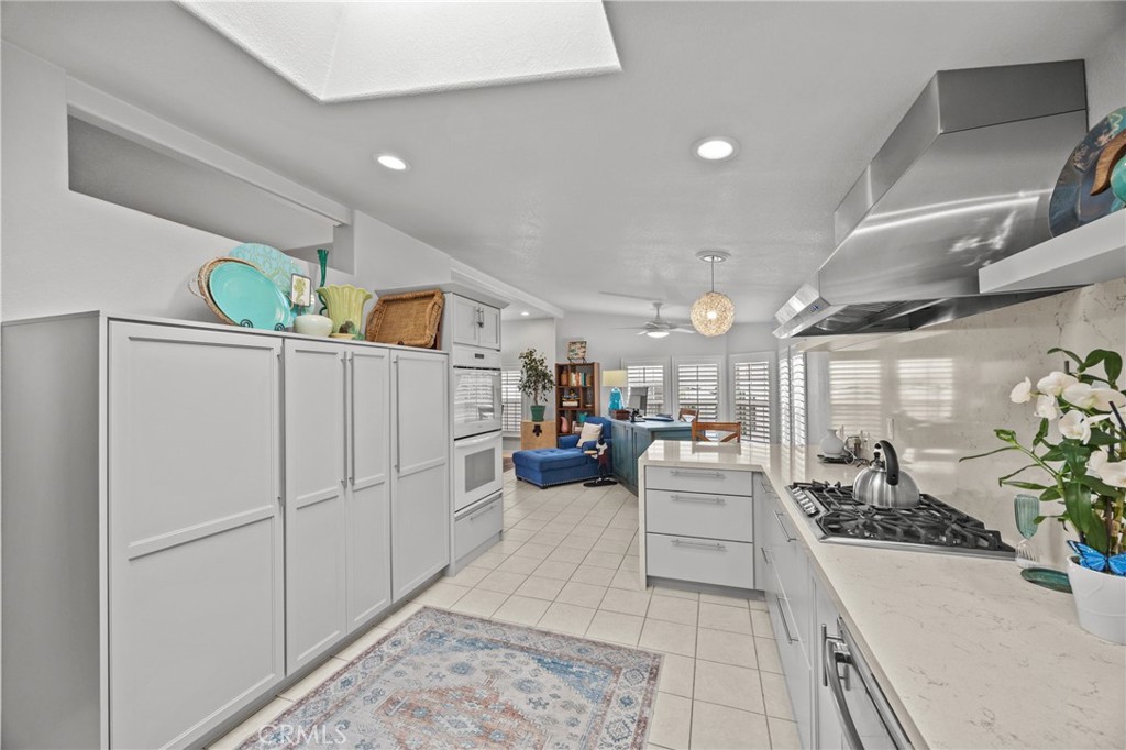 23301 Ridge Rte Drive, Unit 246 Laguna Hills, CA 92653 - Photo 12 of 35 a living room with furniture and a chandelier