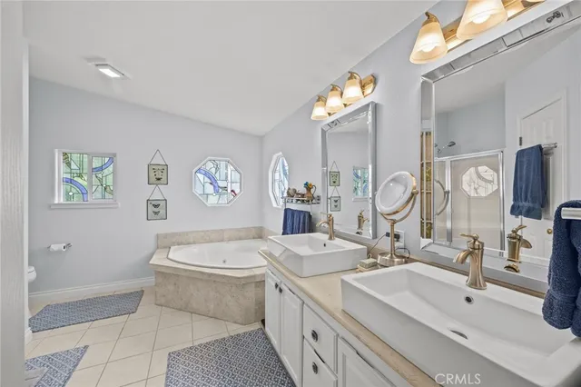 a bathroom with a sink a large mirror and a bathtub