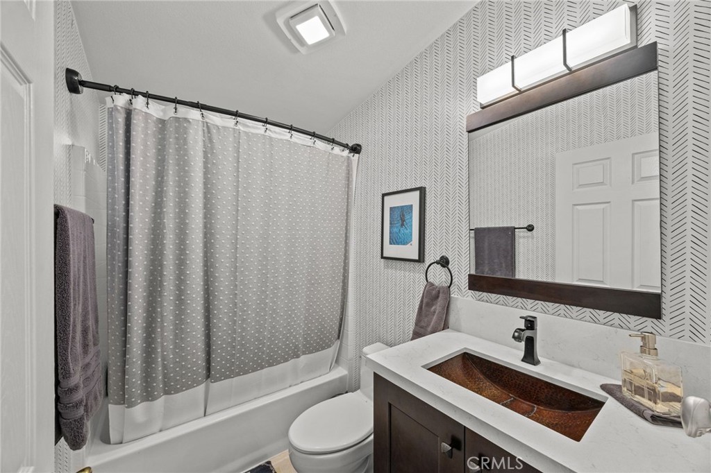 23301 Ridge Rte Drive, Unit 246 Laguna Hills, CA 92653 - Photo 21 of 35 a bathroom with a sink a toilet a mirror and shower