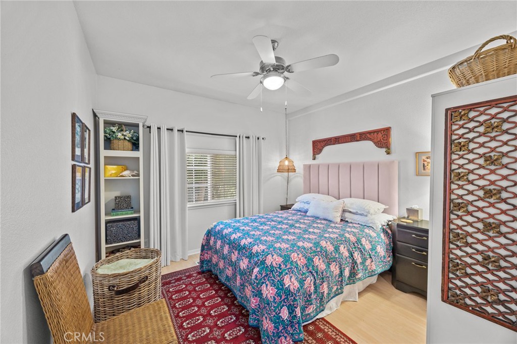 23301 Ridge Rte Drive, Unit 246 Laguna Hills, CA 92653 - Photo 22 of 35 a bedroom with a bed and a chandelier