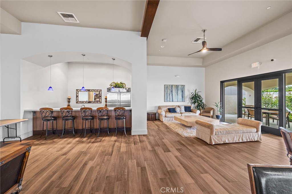 23301 Ridge Rte Drive, Unit 246 Laguna Hills, CA 92653 - Photo 29 of 35 a living room with furniture and a wooden floor