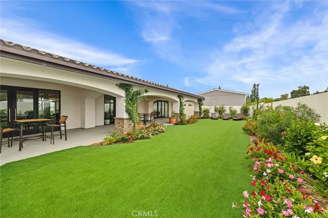a front view of house with a garden and patio