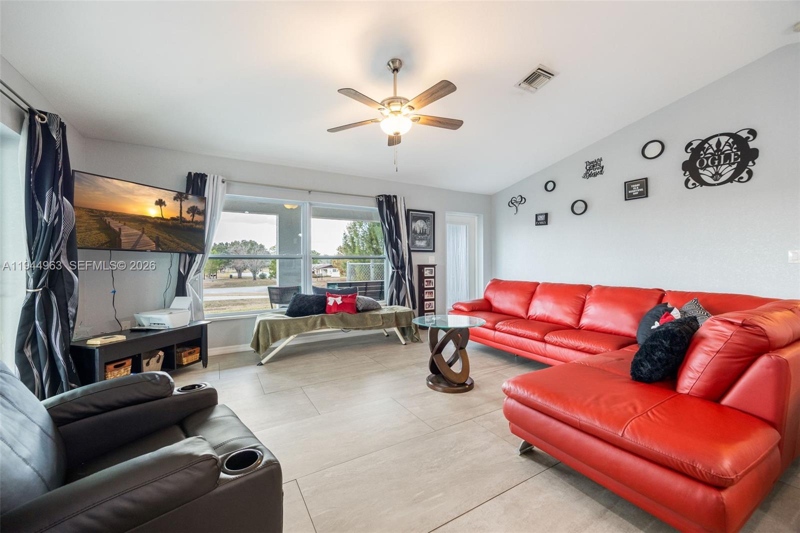 1053 Lock Lane Moore Haven, FL 33471 - Photo 11 of 30 a living room with furniture a couch and a window