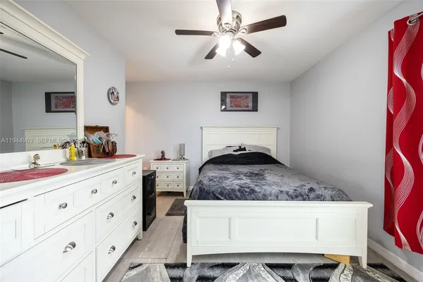 a bedroom with a large bed and a chandelier