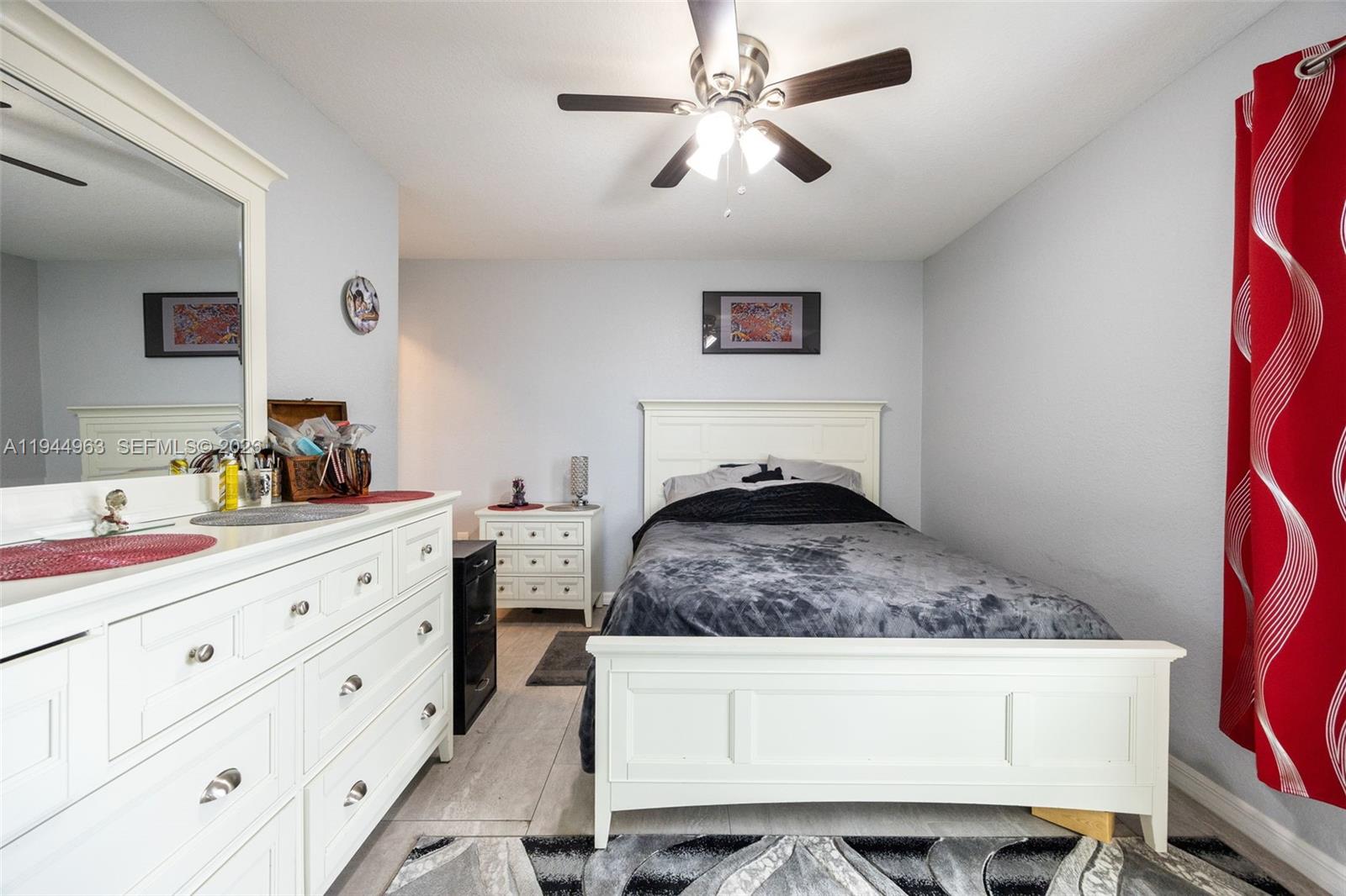 1053 Lock Lane Moore Haven, FL 33471 - Photo 18 of 30 a bedroom with a large bed and a chandelier