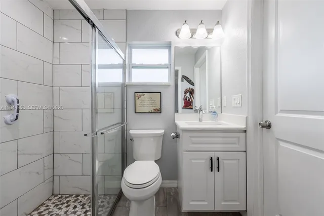 a bathroom with a toilet sink and mirror