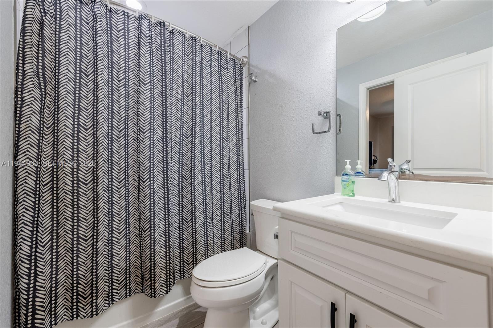 1053 Lock Lane Moore Haven, FL 33471 - Photo 20 of 30 a bathroom with a sink toilet and mirror