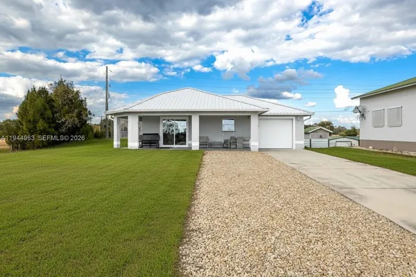 a front view of a house with a garden