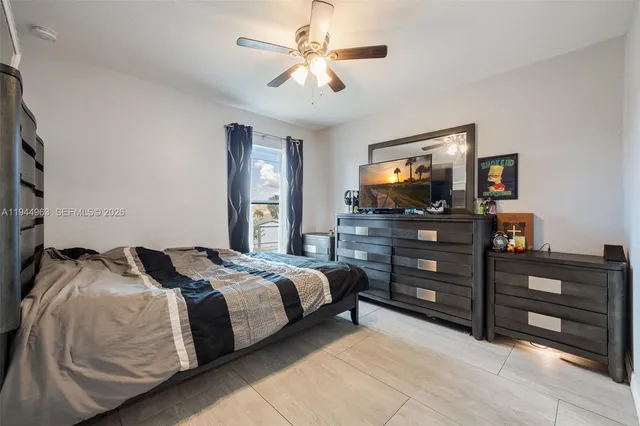 a bedroom with a bed and a television