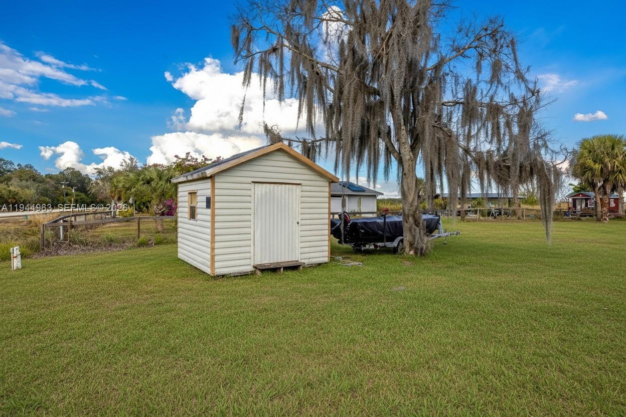 1053 Lock Lane Moore Haven, FL 33471 - Photo 23 of 26 a view of a house with a yard