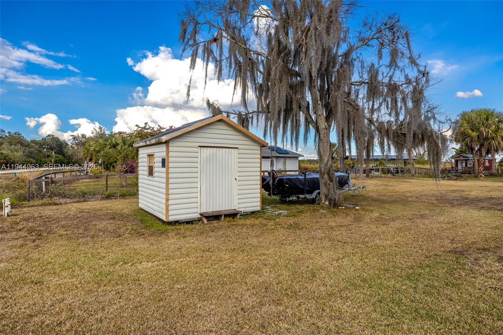 1053 Lock Lane Moore Haven, FL 33471 - Photo 25 of 30 a view of a house with a yard