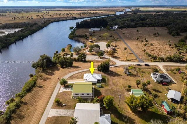 an aerial view of swimming pool with outdoor seating