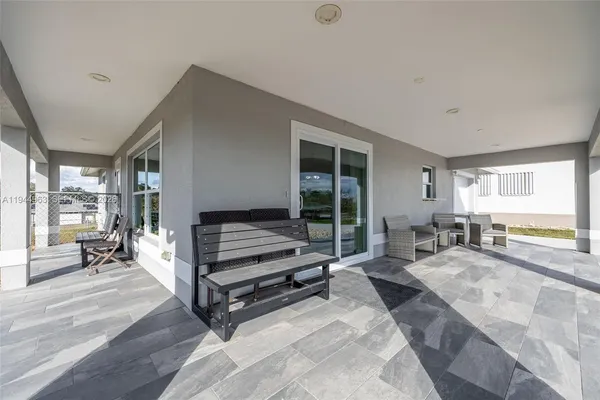 a bedroom with furniture and a large window