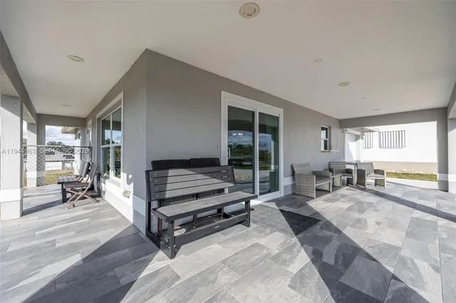 a bedroom with furniture and a large window