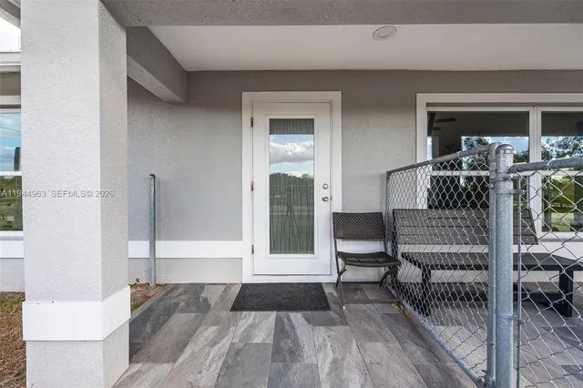 a view of front door deck and furniture