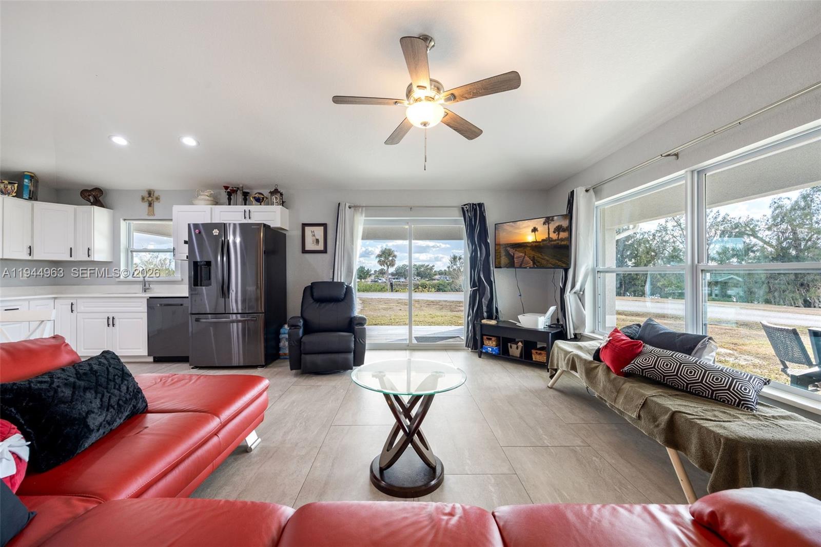 1053 Lock Lane Moore Haven, FL 33471 - Photo 10 of 30 a living room with furniture gym equipment and a large window