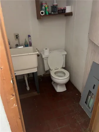 a toilet sitting in a bathroom next to a sink