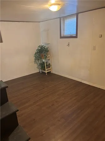 a view of a room with wooden floor and bench