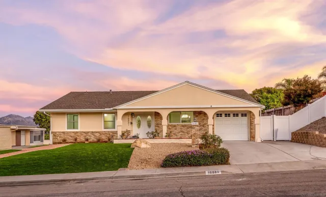a front view of a house with a garden
