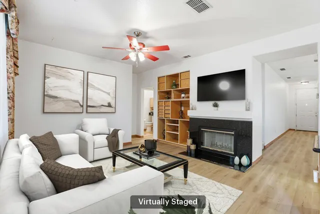 a living room with furniture a fireplace and a flat screen tv