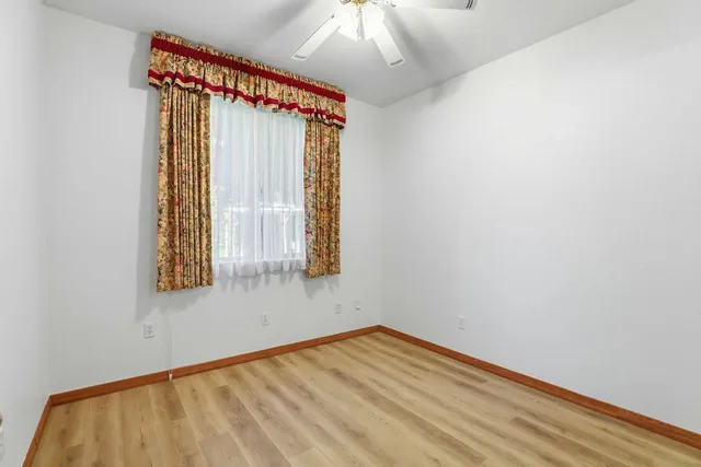 a bathroom with a granite countertop sink and a toilet
