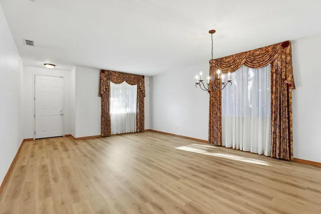 a view of a room with wooden floor and stairs