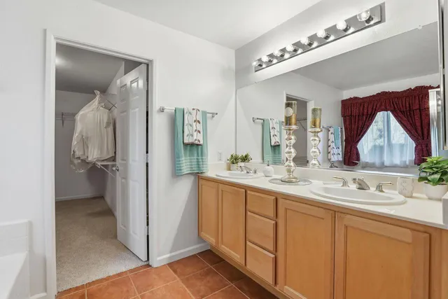 an empty room with a mirror and a fan