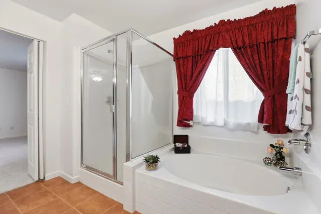 an empty room with a ceiling fan and entryway