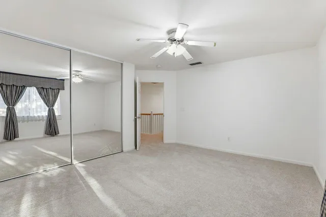 an empty room with a view of a livingroom