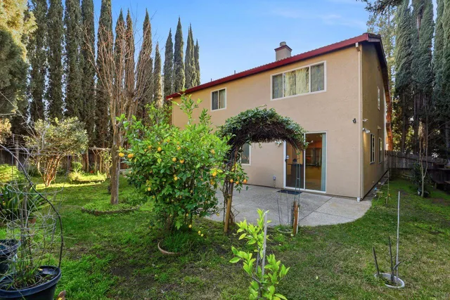 a front view of a house with a yard table and chairs